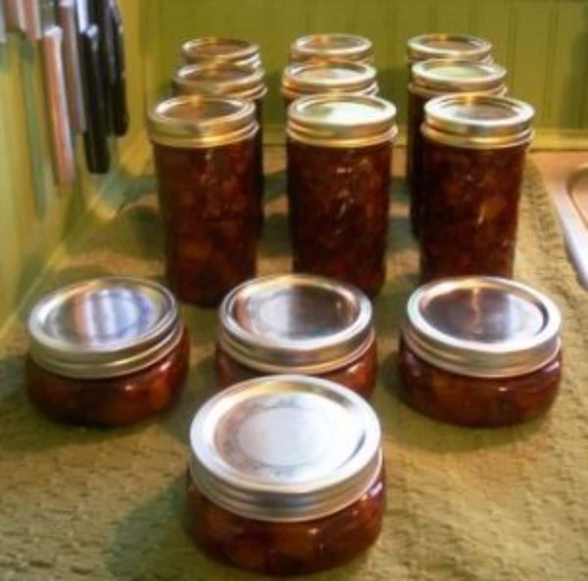 Spicy pear chutney in glass jars.