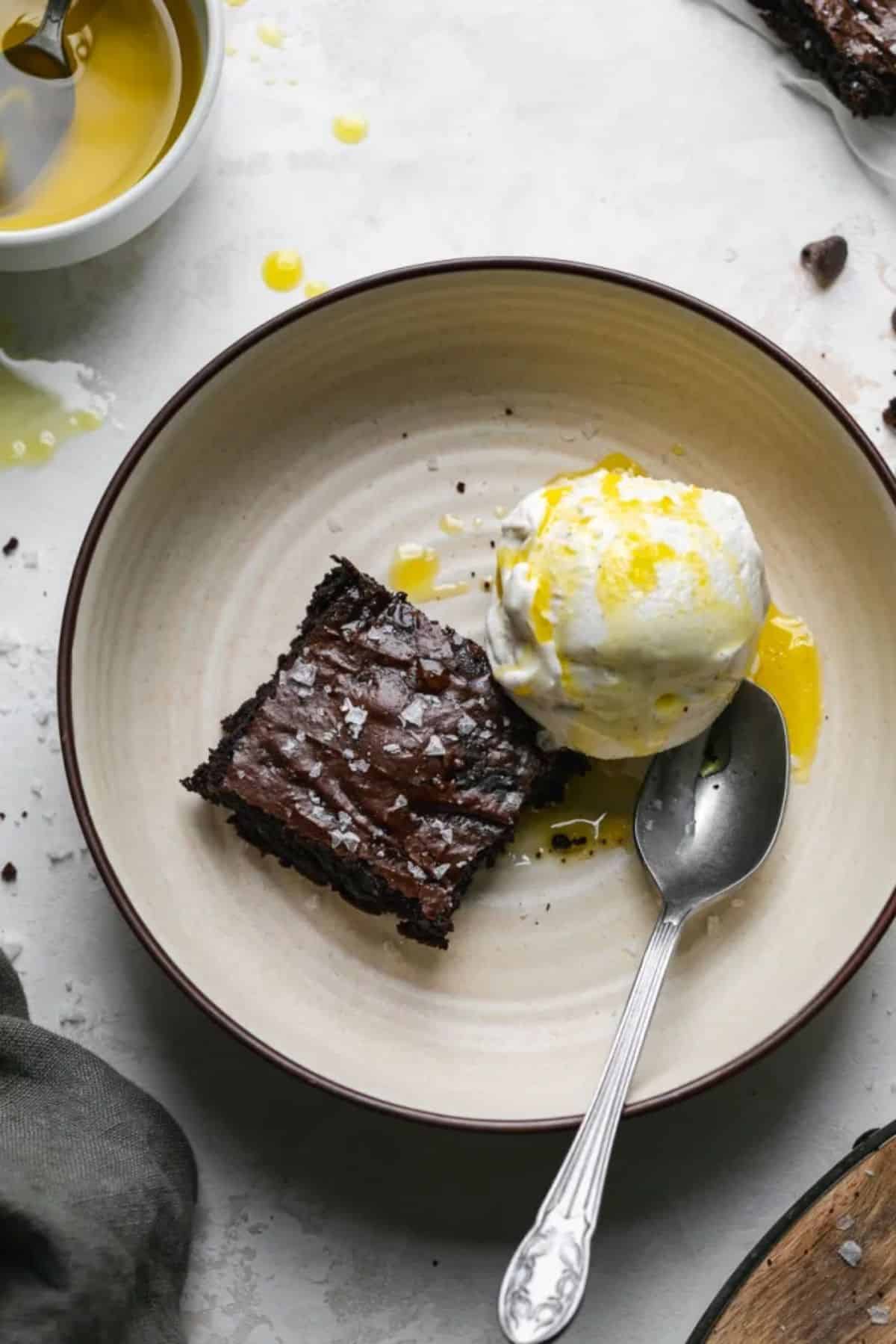Delicious fudgy olive oil brownie on a gray plate.