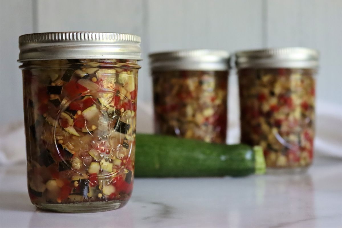 Zucchini relish canned in glass jars.