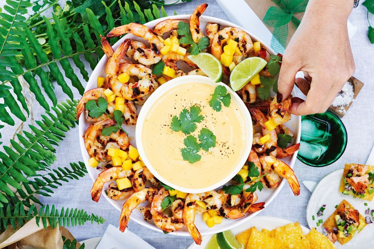 Bbq prawns with mango mayonnaise on a white tray.