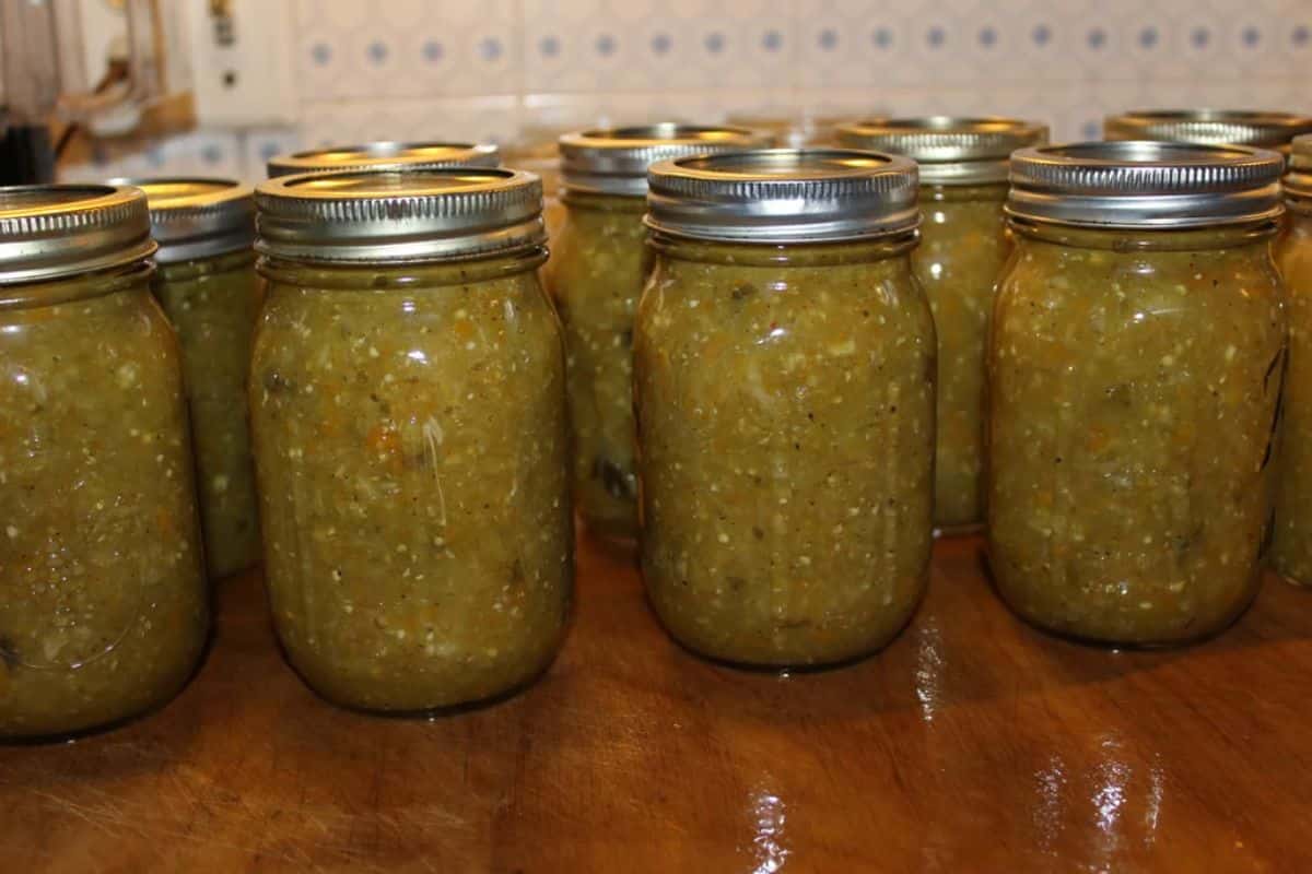 Green tomato salsa canned in glass jars.