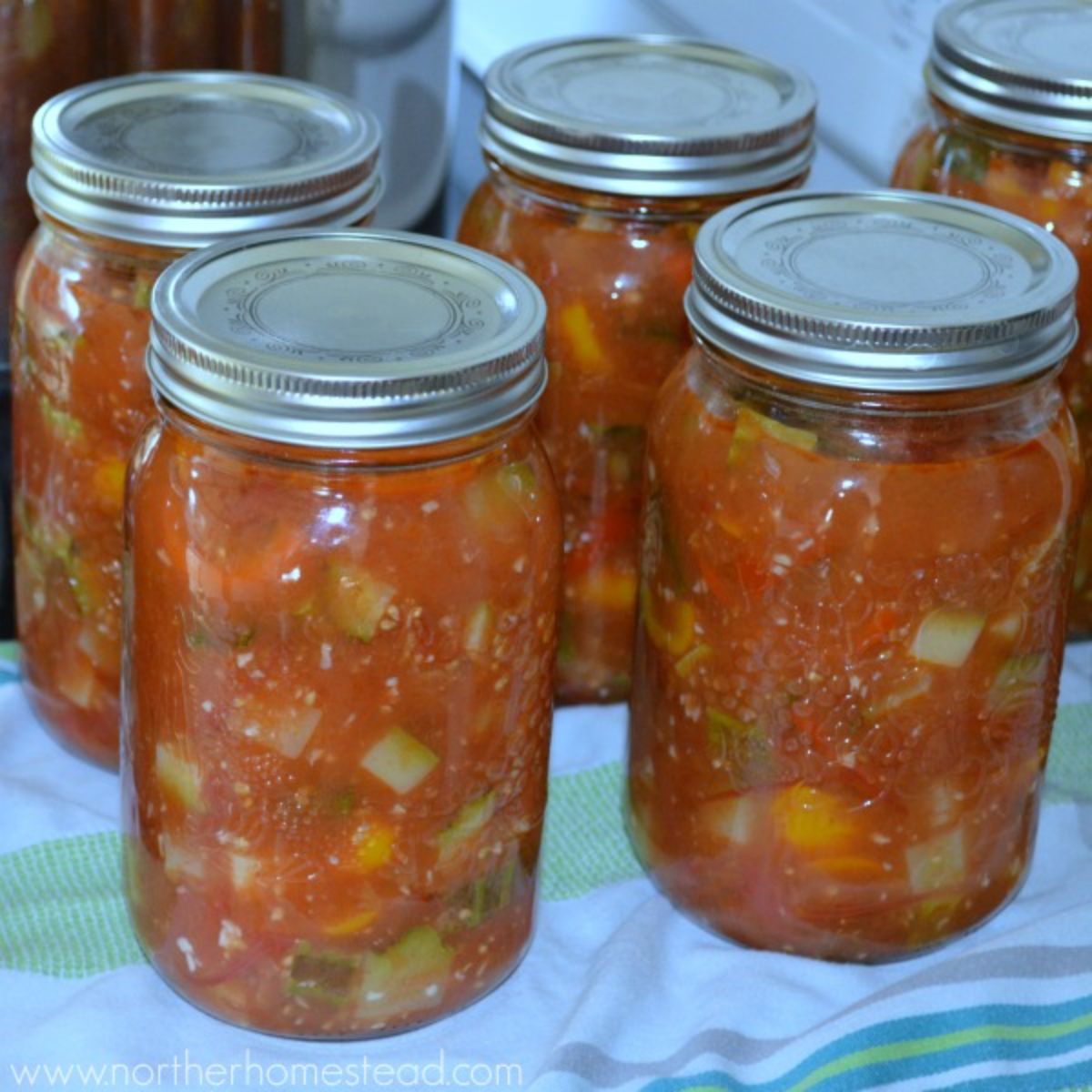 Canned zucchini salad in glass jars.