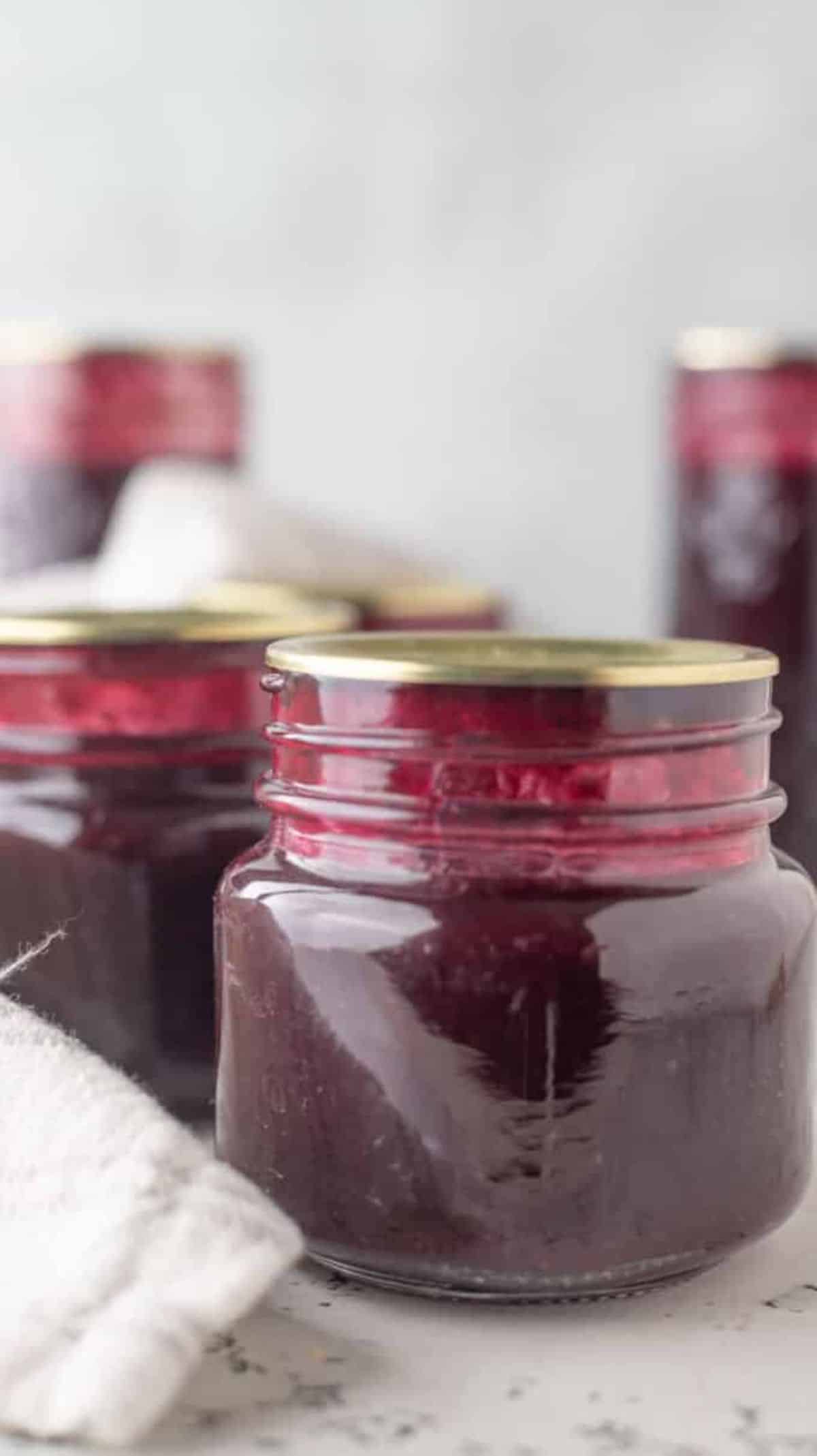 Blueberry syrup canned in glass jars.