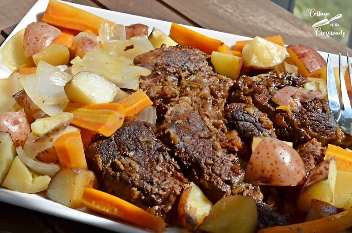 Mom's beef pot roast with veggies on a white tray.