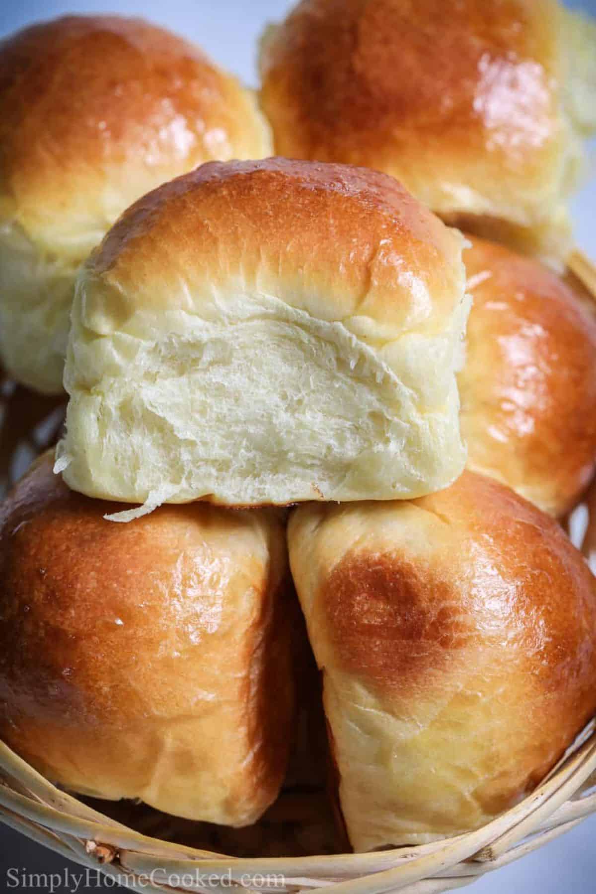 Delicious  super soft brioche dinner rolls in a wicker basket.