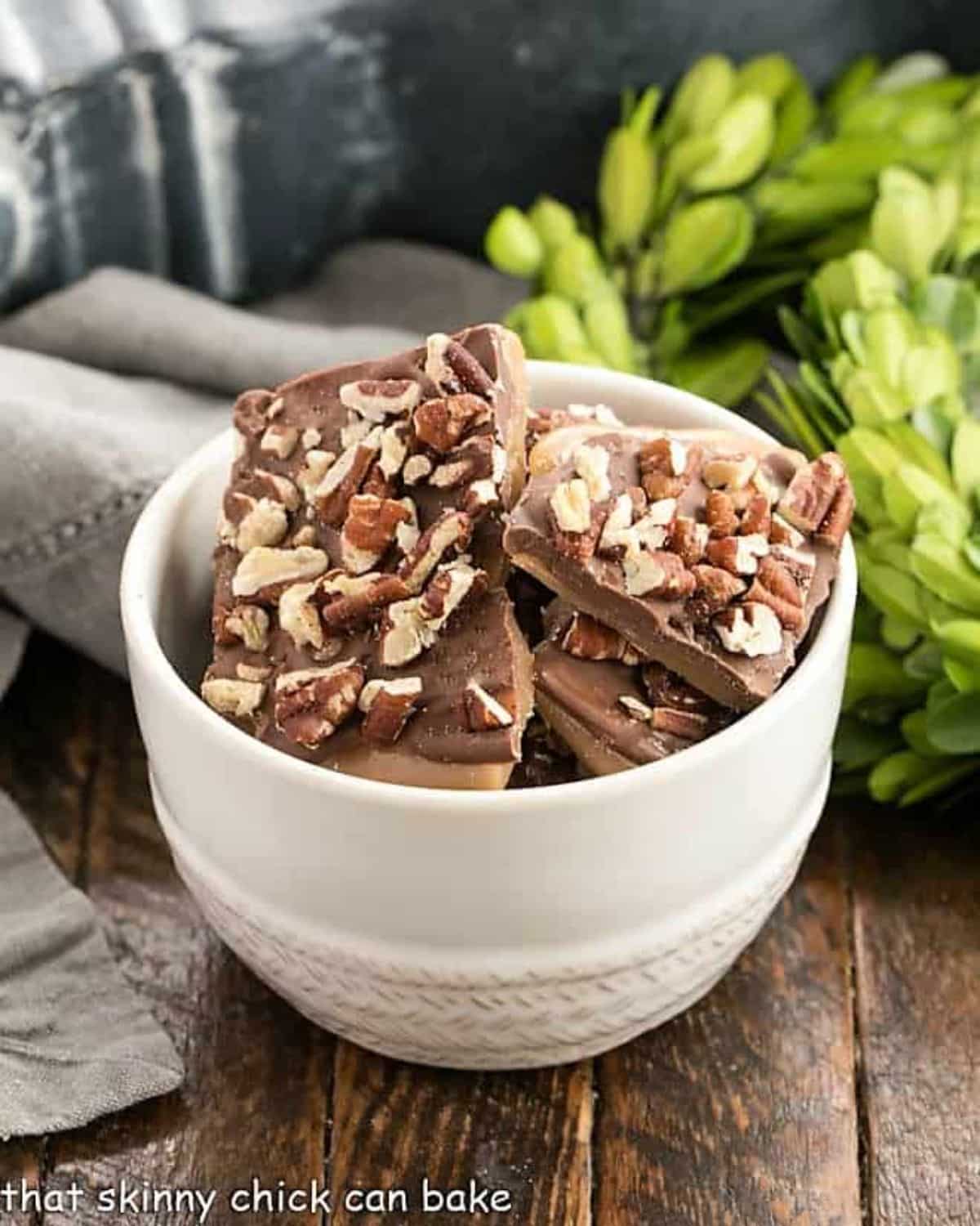 Scrumptious english toffee in a white bowl.