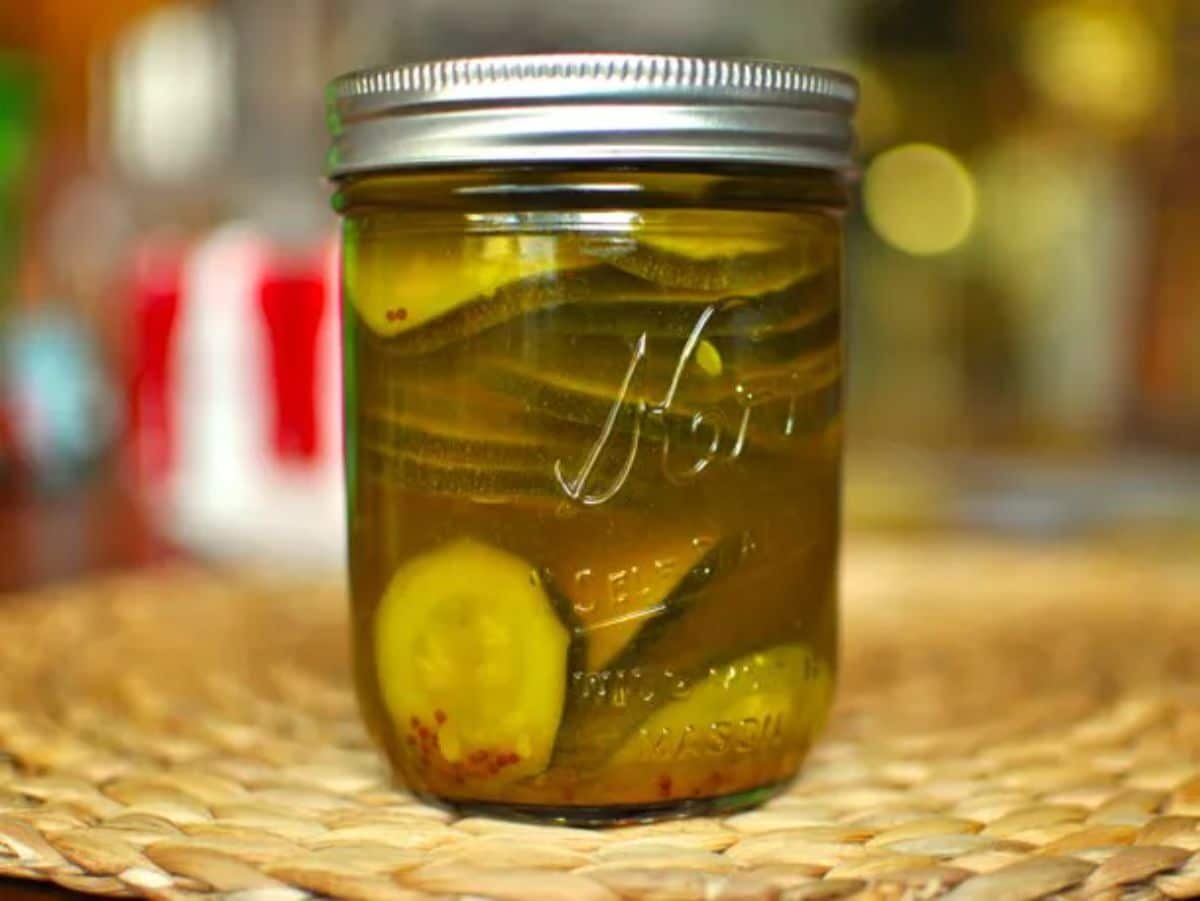 Curried pickled zucchini in a glass jar.