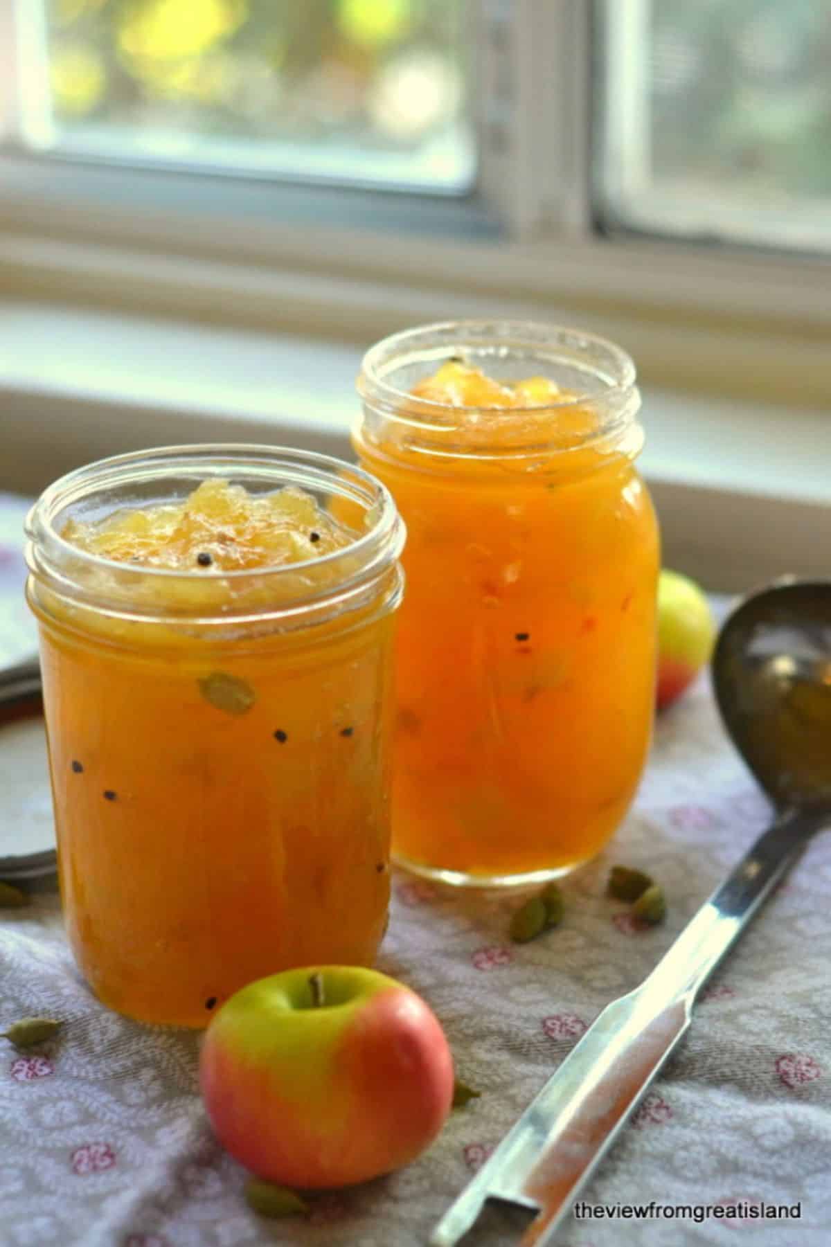 French apple jam with cardamom in two glass jars.