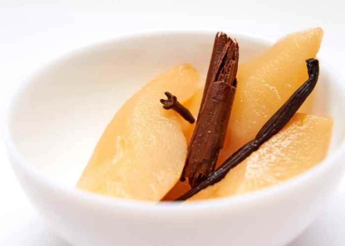 Canned spice vanilla pears in a white bowl.