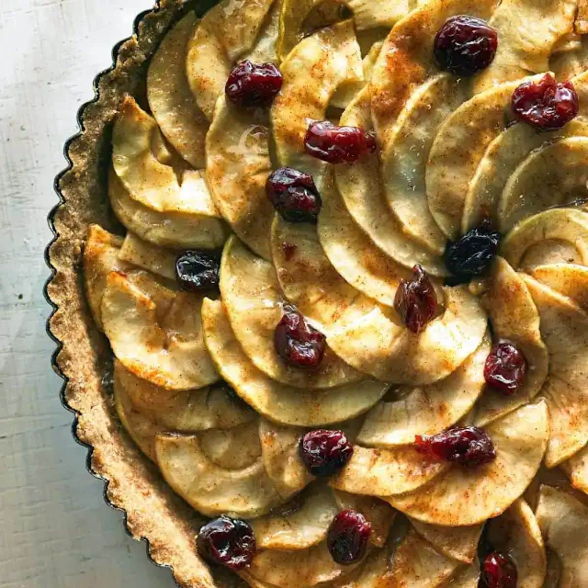 Apple cranberry tart in a tray.