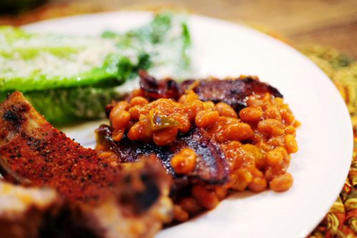 Juicy baked beans on a white plate.