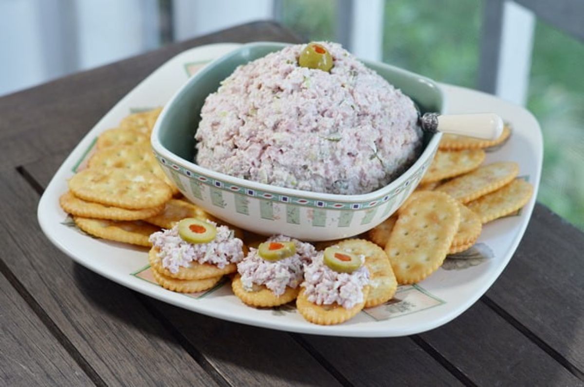 Delicious ham salad in a bowl with crackers on a plate.
