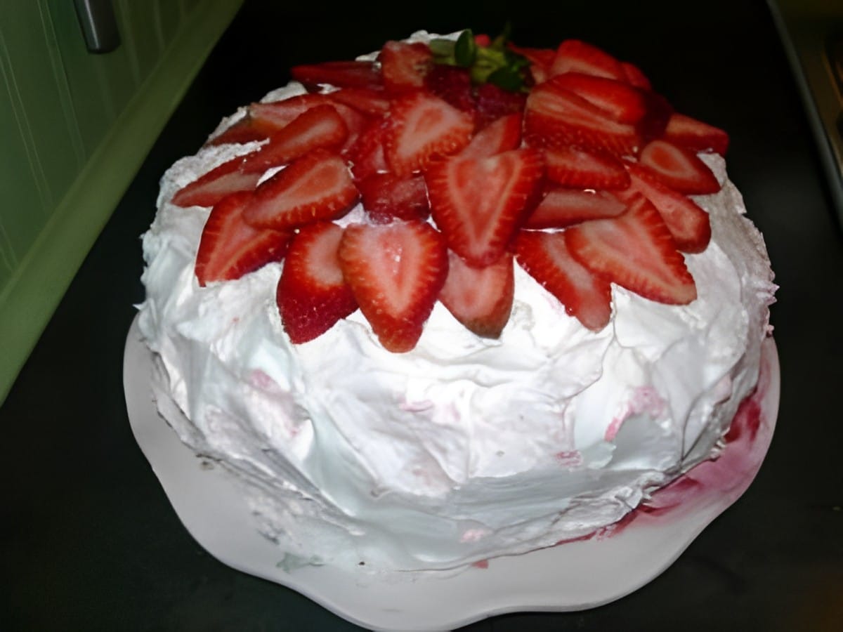 Award-winning strawberry cake on a white tray.