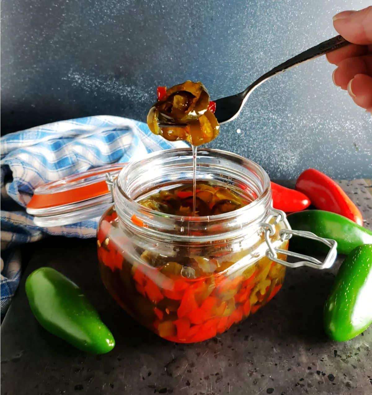 Cowboy candy in a glass jar picked with a fork.