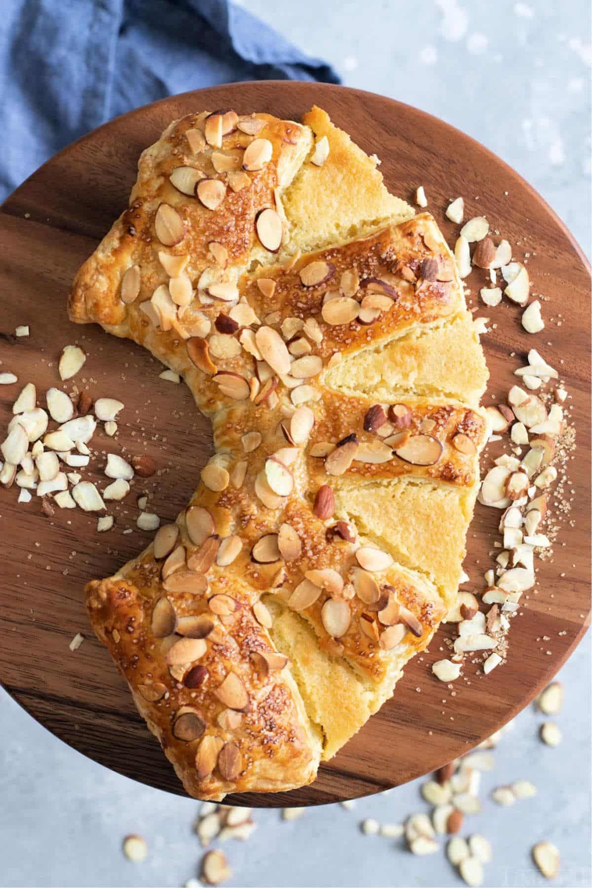 Almond bear claw on a wooden tray.