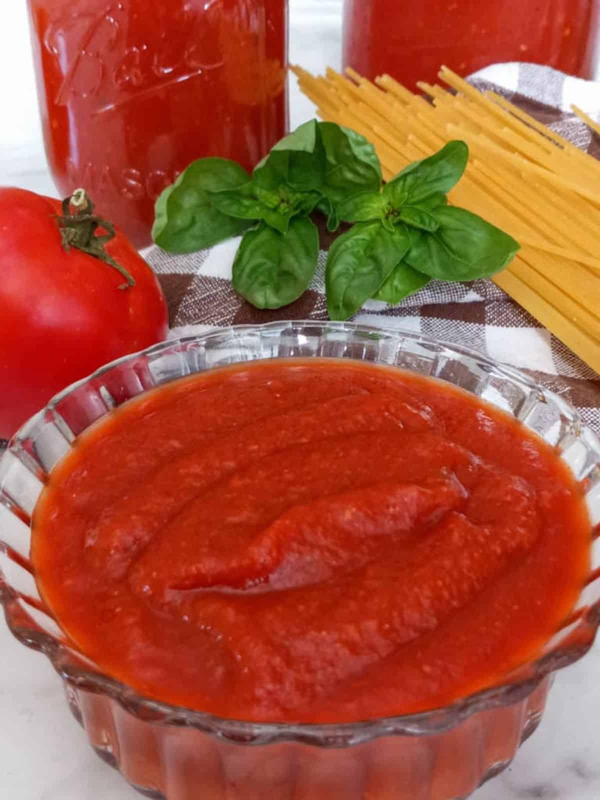 Amish canned pizza sauce in a glass bowl.