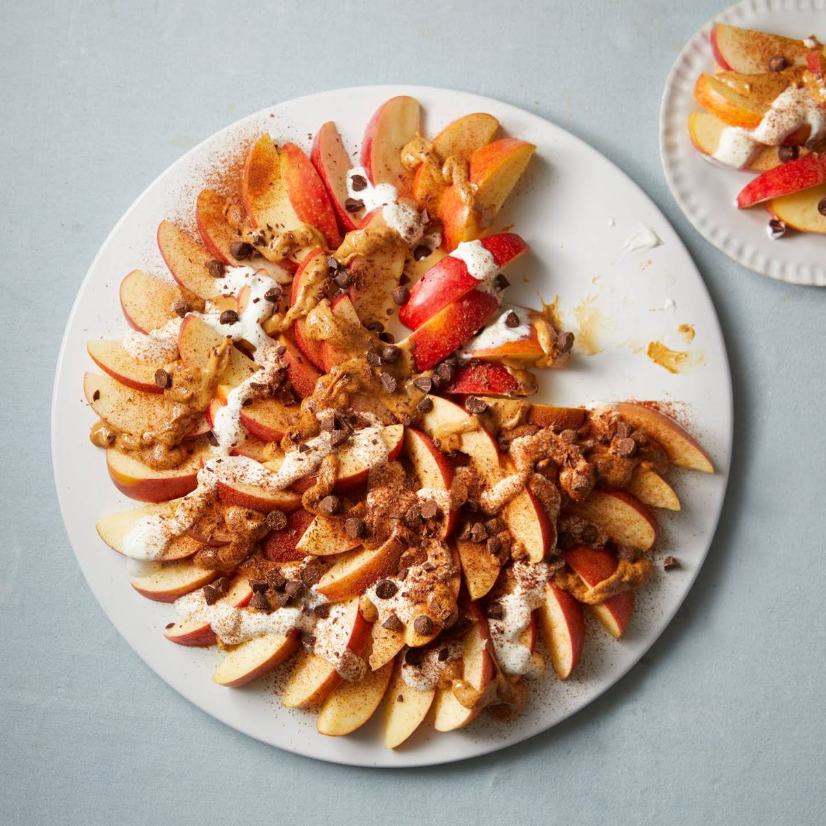 Healthy apple nachos on a white plate.