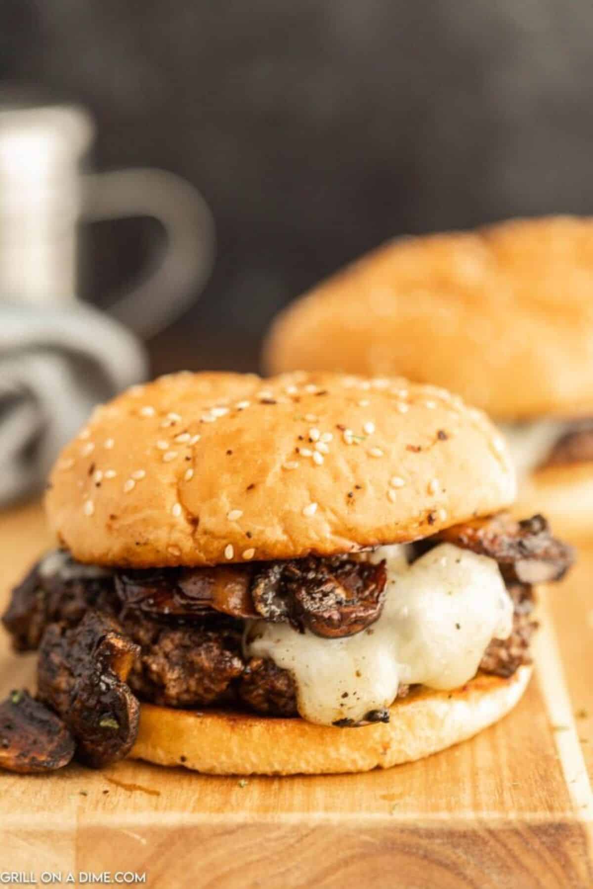 Blackstone mushroom swiss burger on a wooden tray.