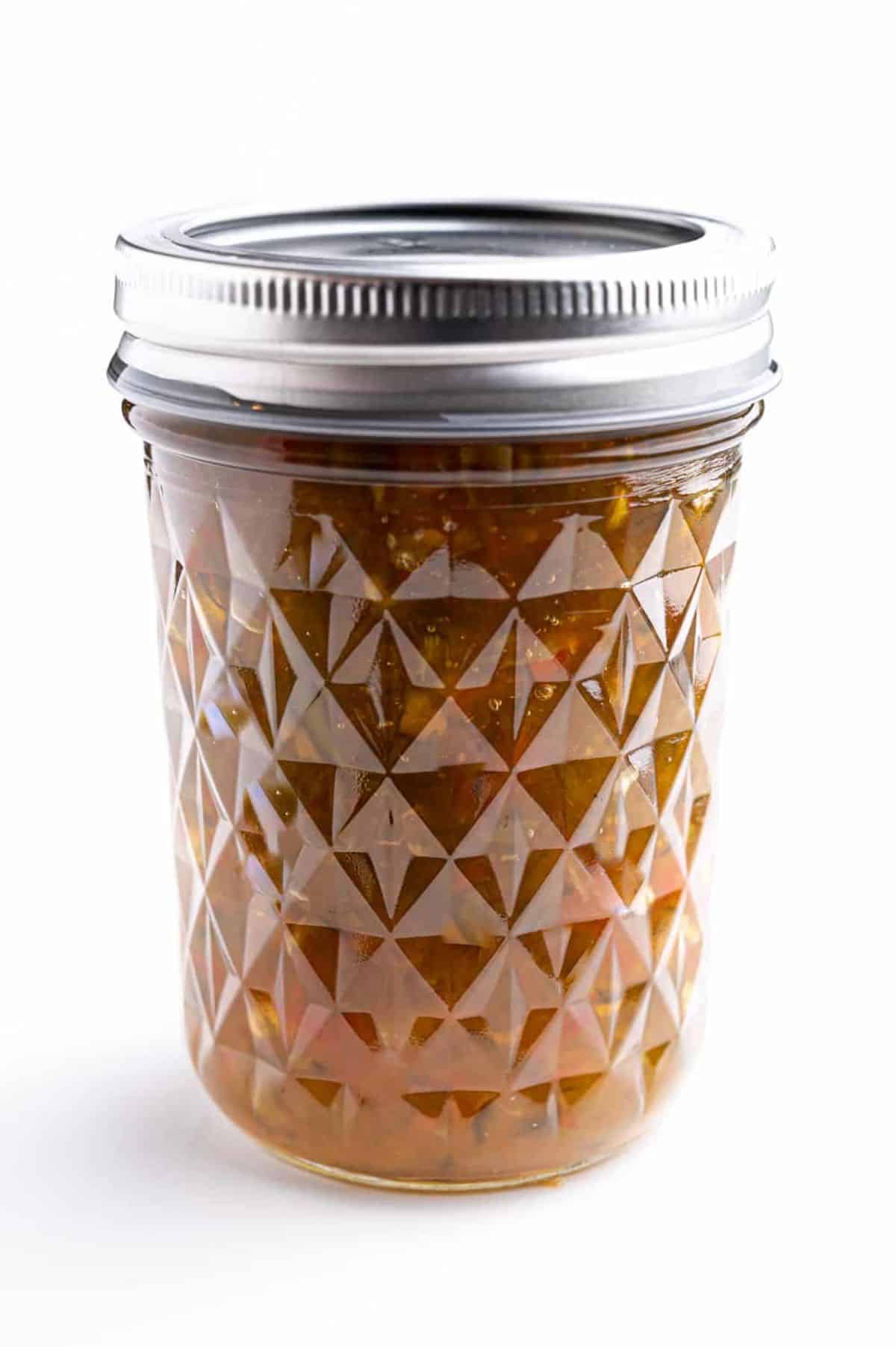 Jalapeno pepper jelly canned in a glass jar.