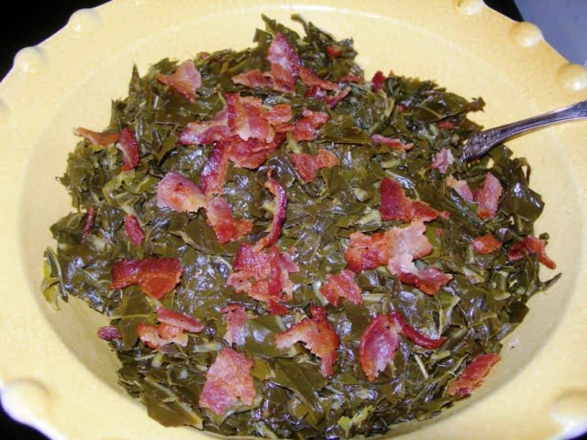Collard greens with bacon on a yellow plate.
