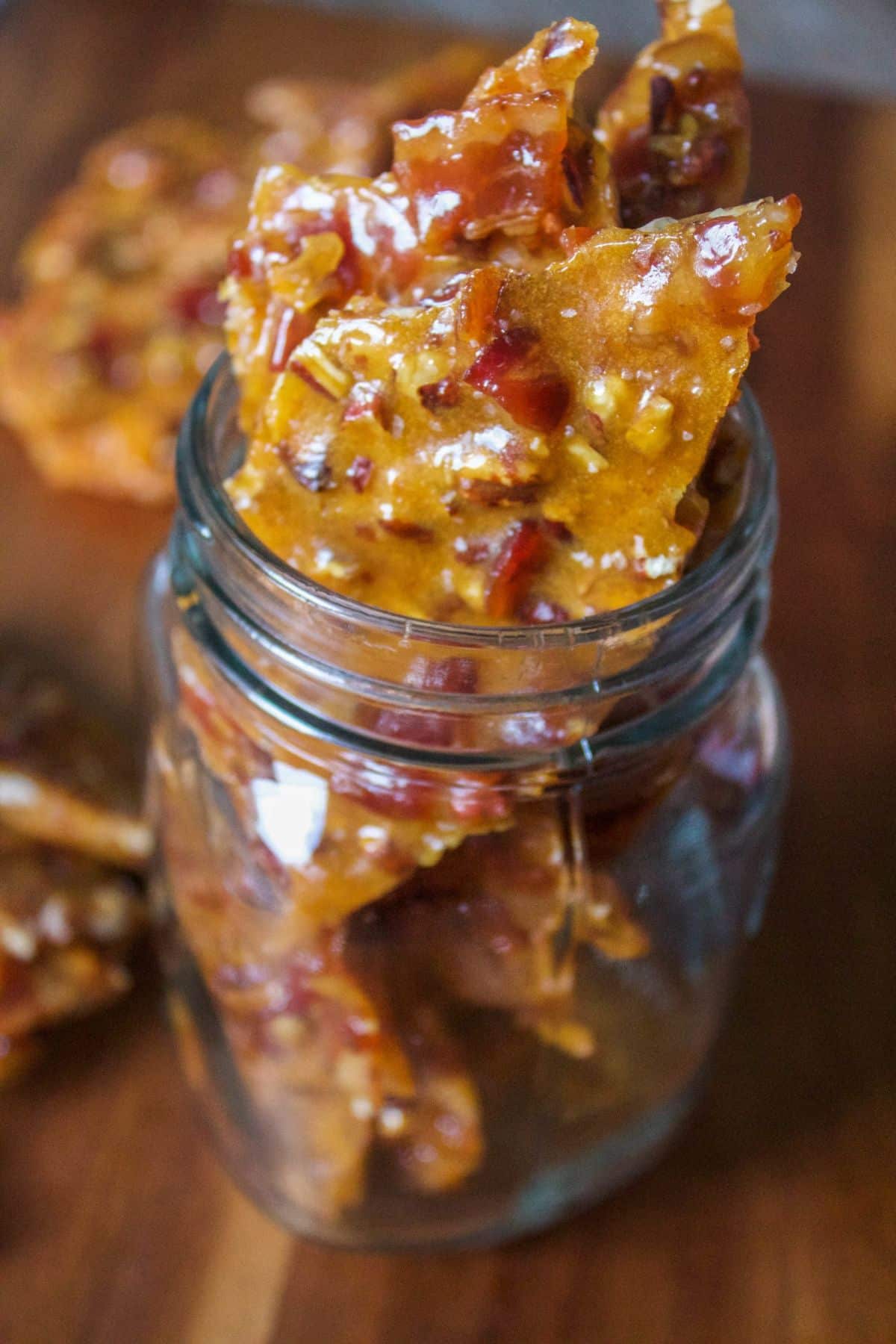 Crunchy bourbon bacon brittles in a glass jar.