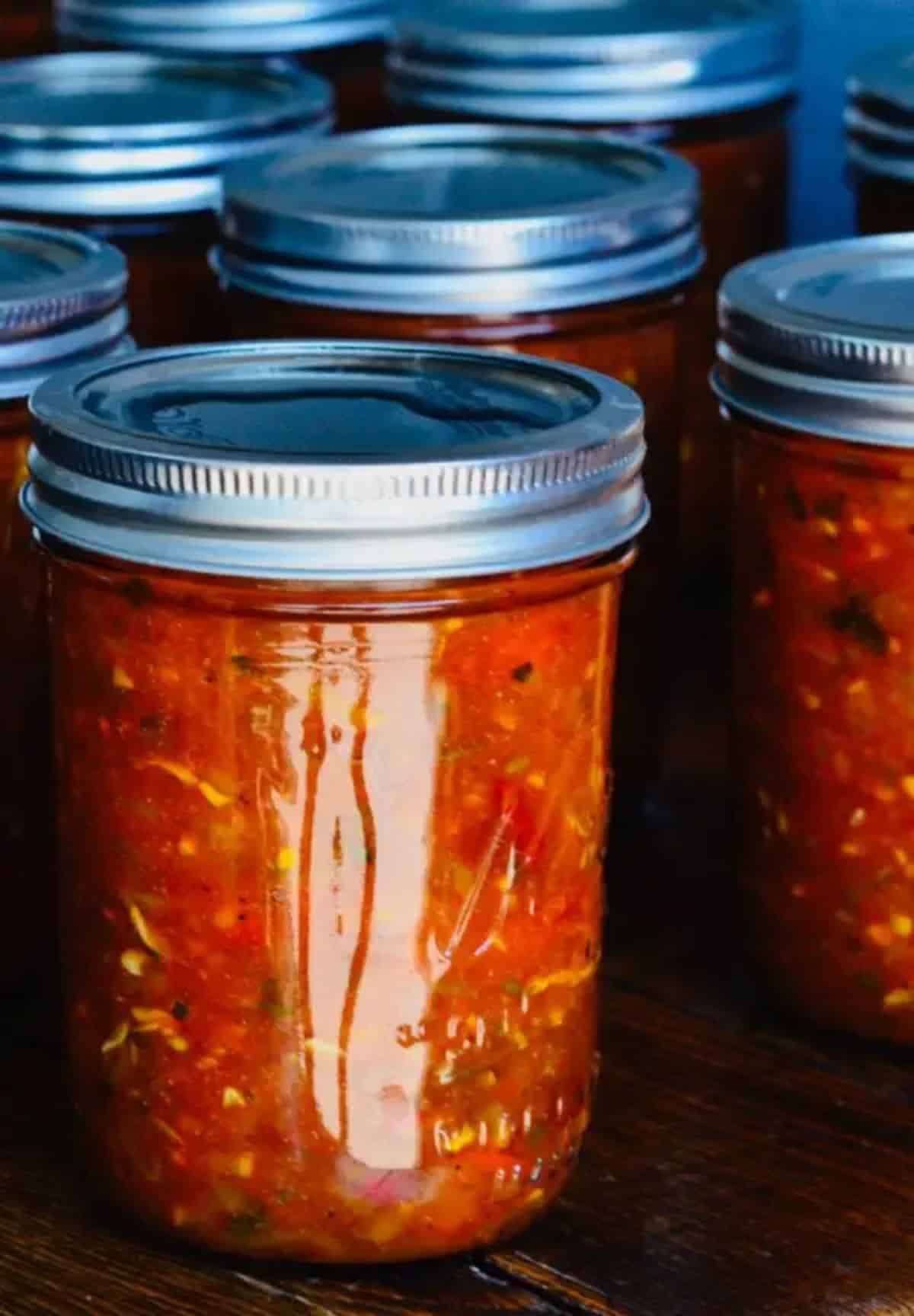 Sweet smokey zucchini salsa canned in glass jars.