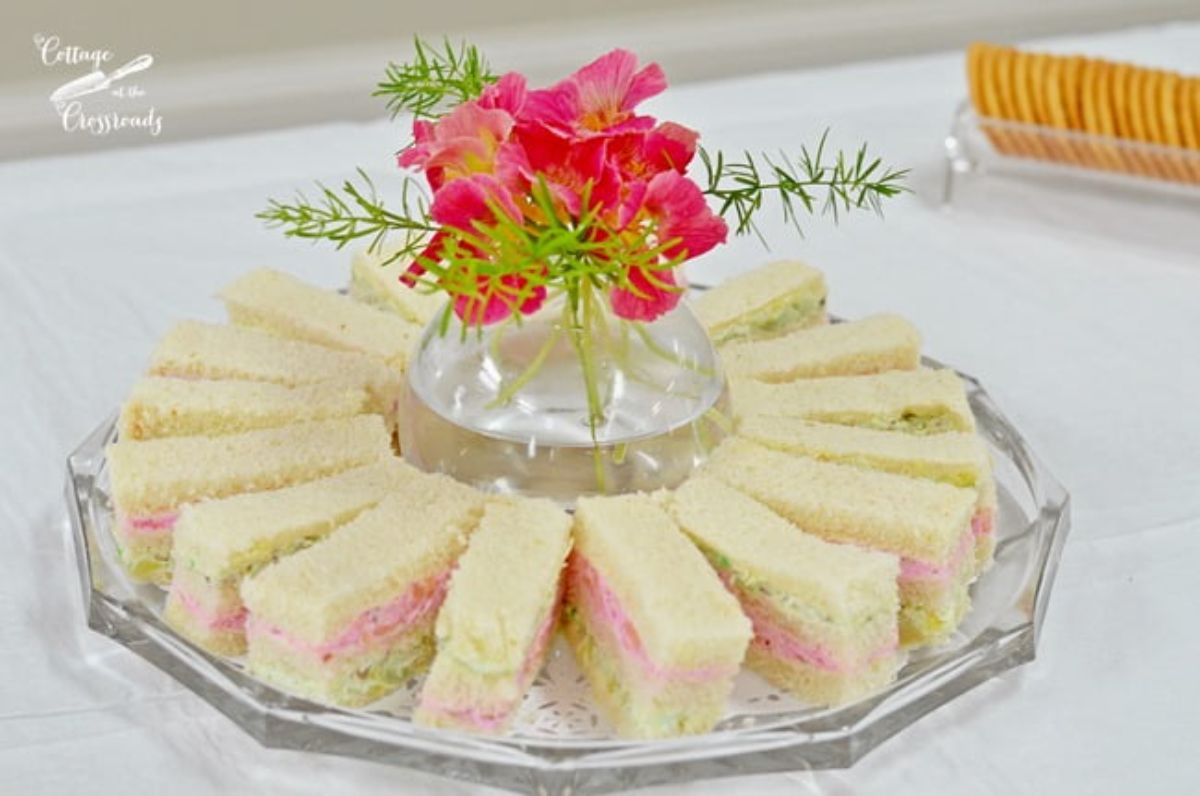 Delicious pretty layered ribbon sandwiches on a cake tray.
