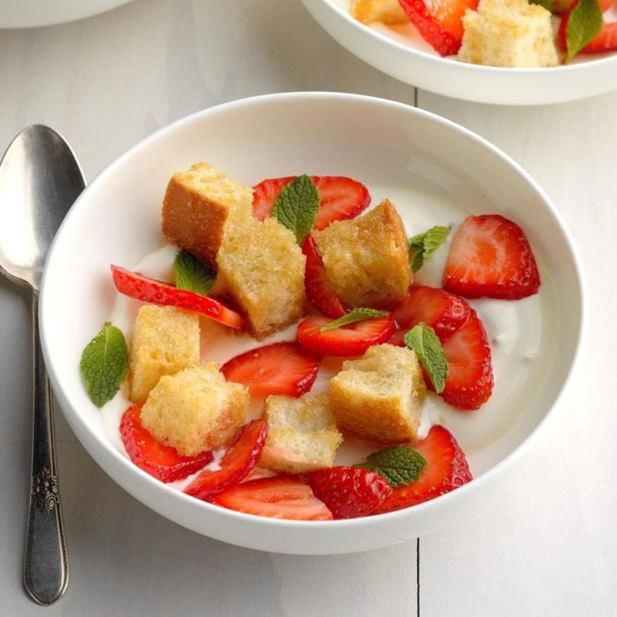 Healthy strawberry panzanella salad in a white bowl.