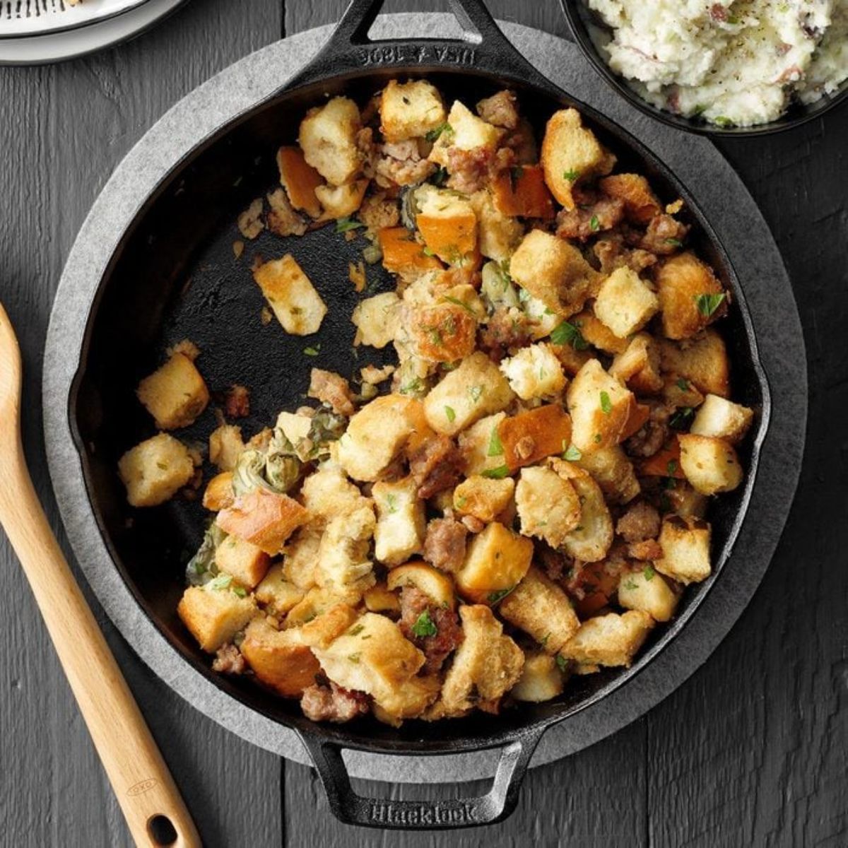 Crispy oyster sausage stuffing in a black skillet.