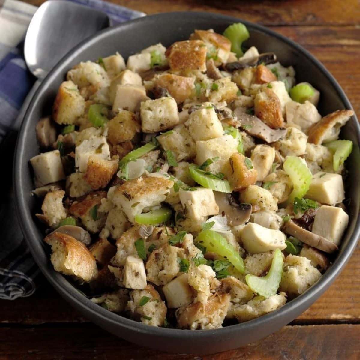 Tasty chicken and stuffing in a black pot.