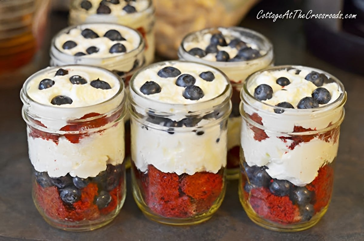 Delicious dessert in glass jars on a table.