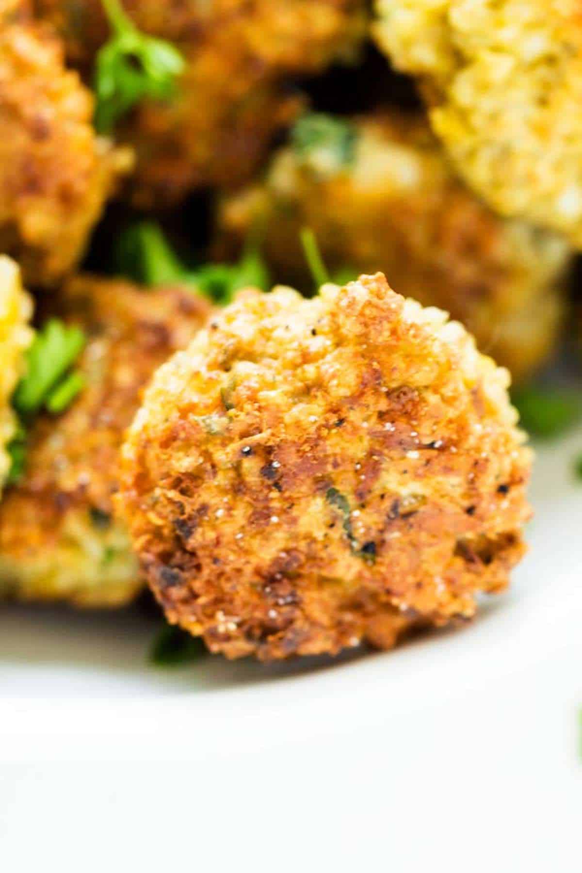 Crispy quinoa fritters on a plate.