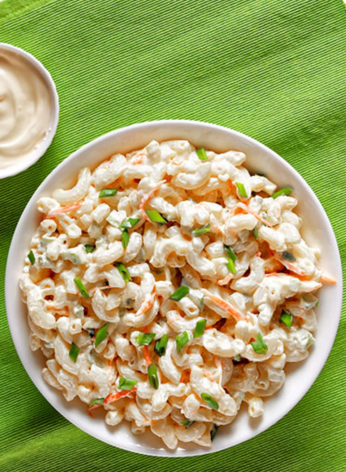 Mouth-watering macaroni salad in a white bowl.