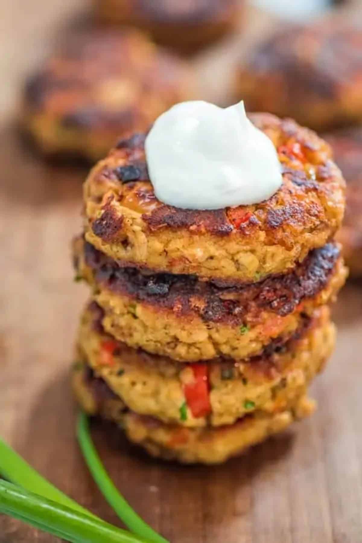 A pile of crunchy easy salmon patties on a wooden tray.