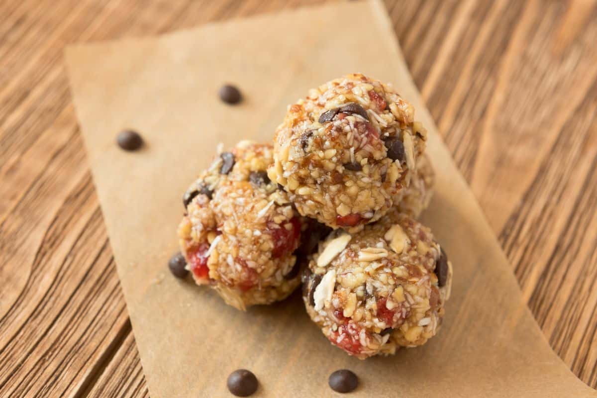 Delicious oatmeal raisin peanut butter balls on a wooden table.
