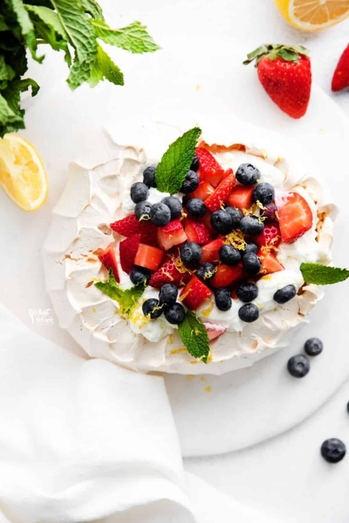 Scrumptious classic pavlova cake on a tray.