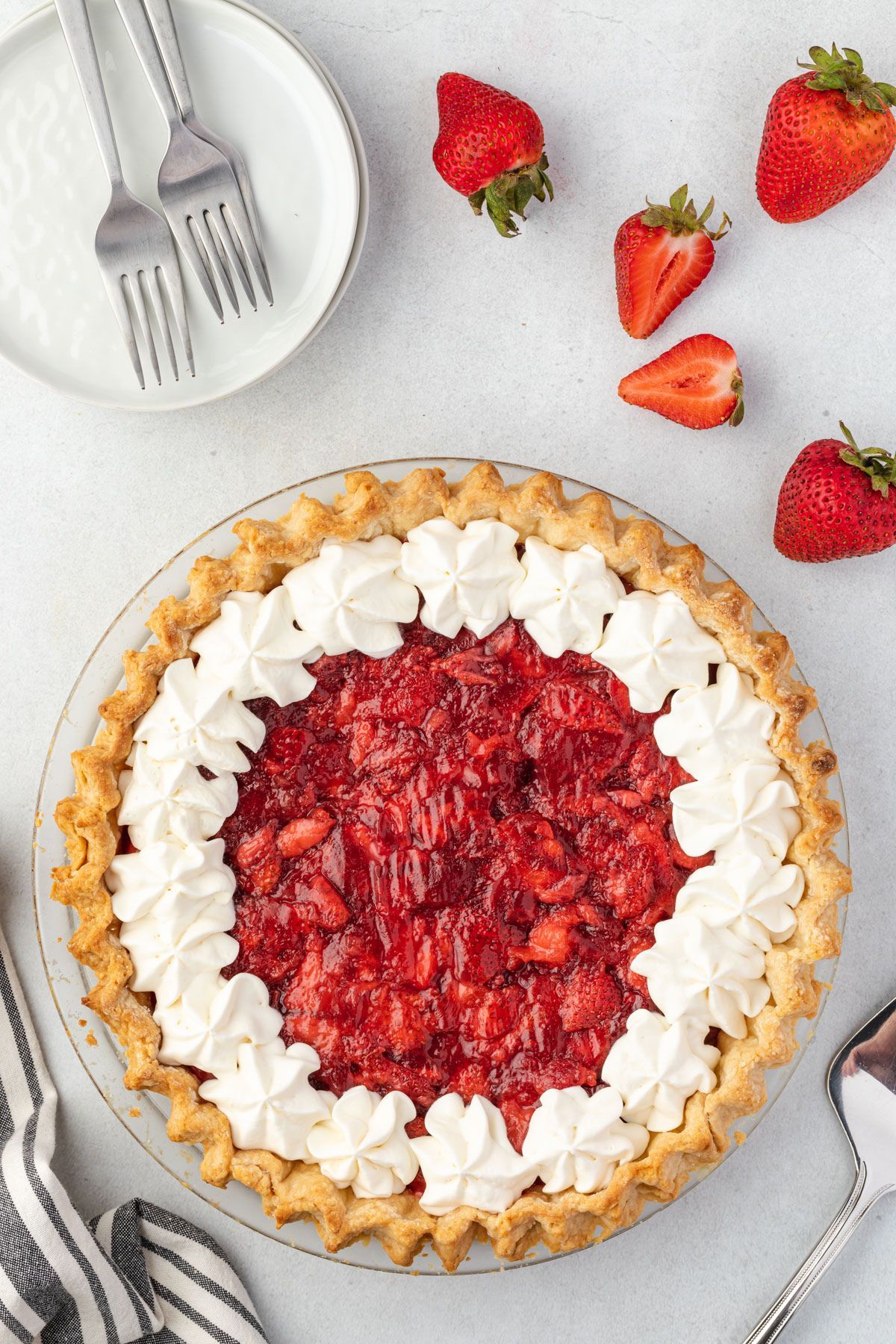 Mouth-watering homemade strawberry pie filling on a cake tray.