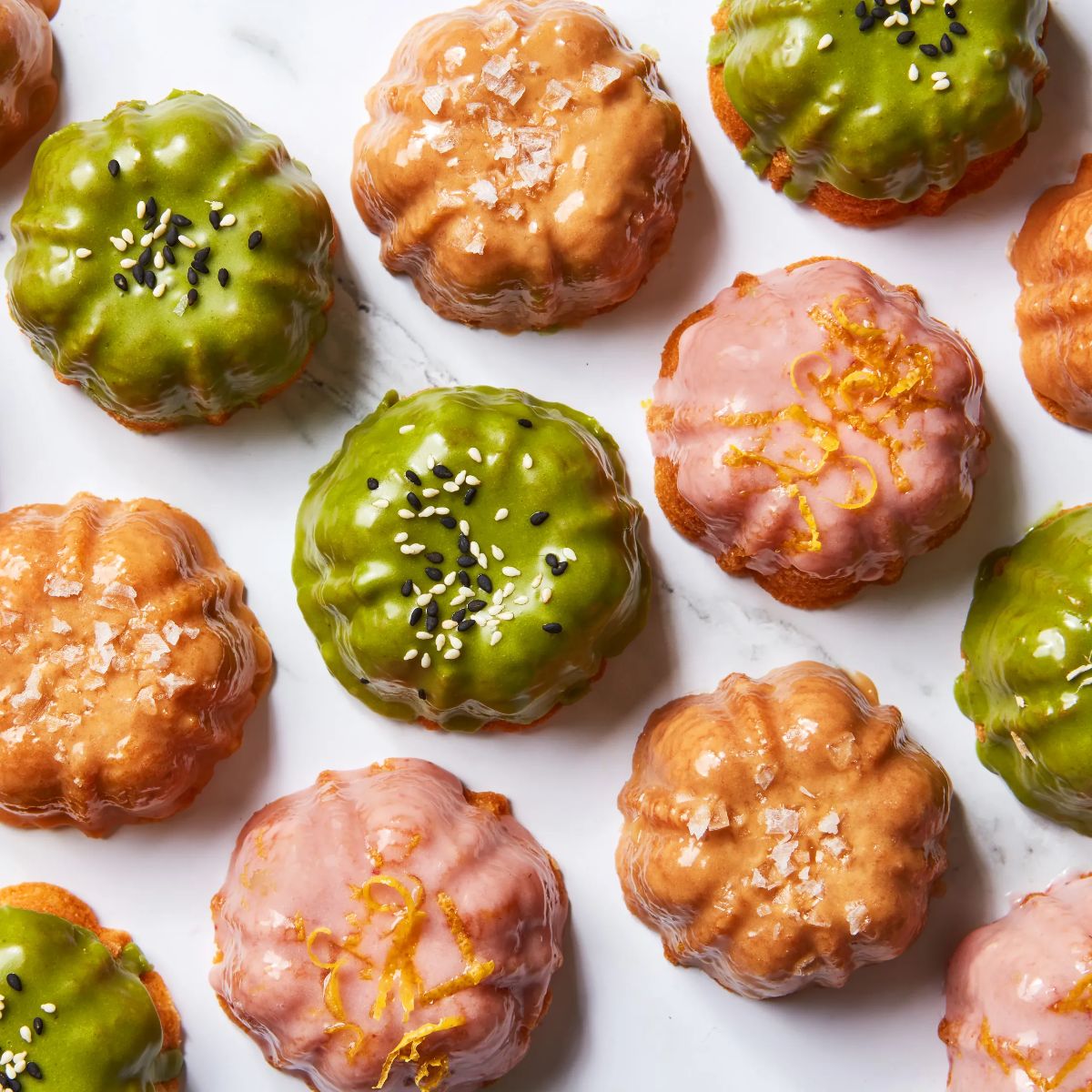 Crunchy glazed sour cream gem cakes on a table.