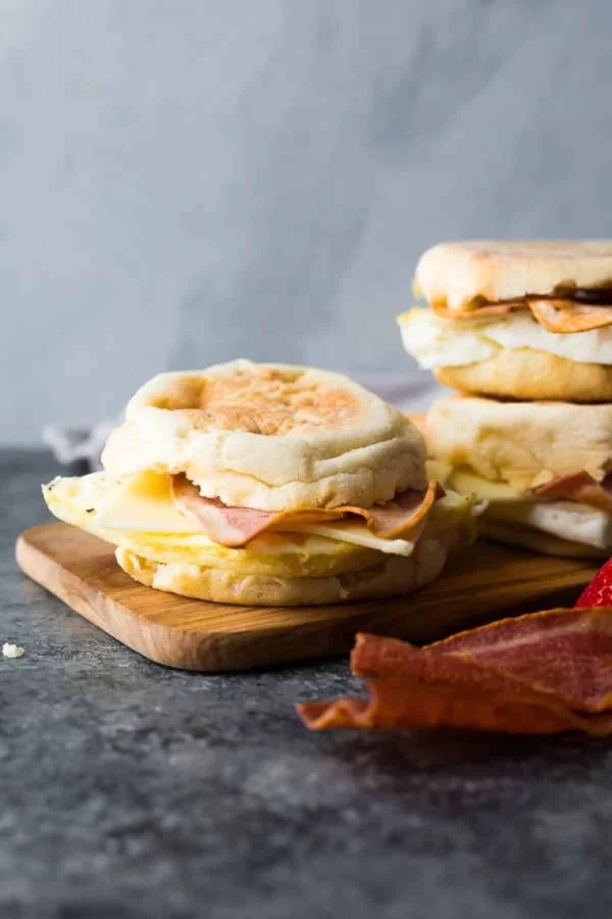 Tasty copycat starbucks egg white breakfast sandwiches on a wooden cutting board.