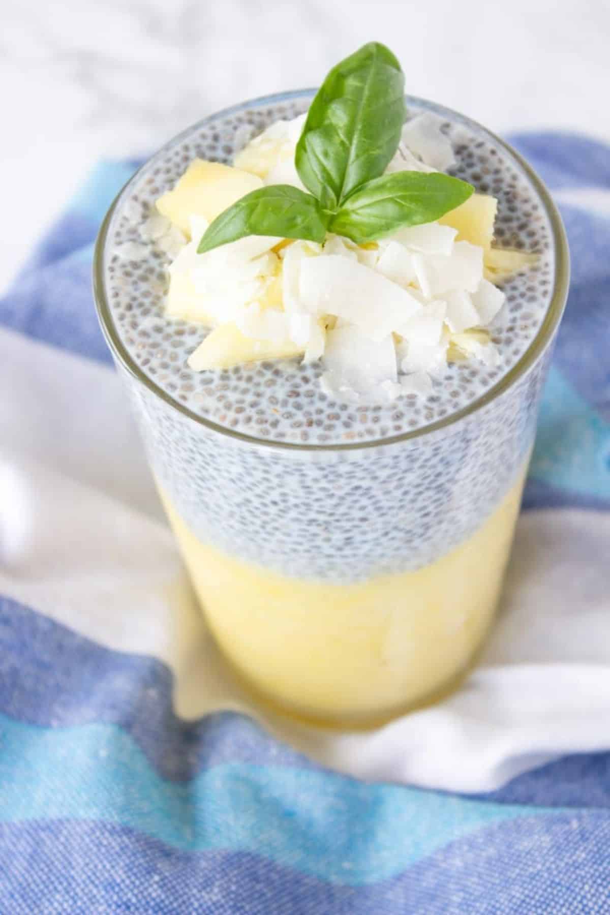 Creamy pineapple and coconut chia style pudding in a glass cup.