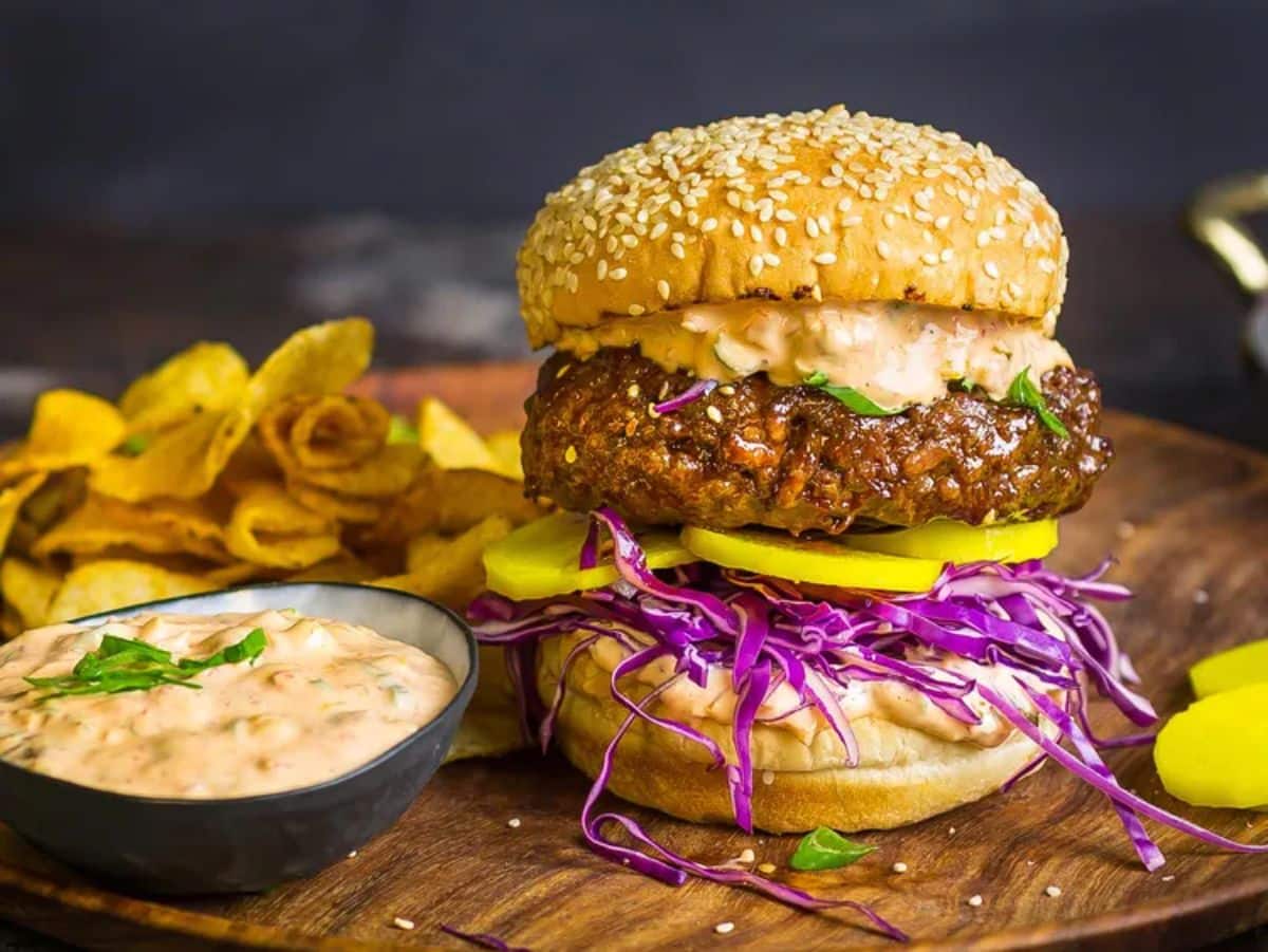 Scrumptious korean-style bulgogi burger on a wooden tray.