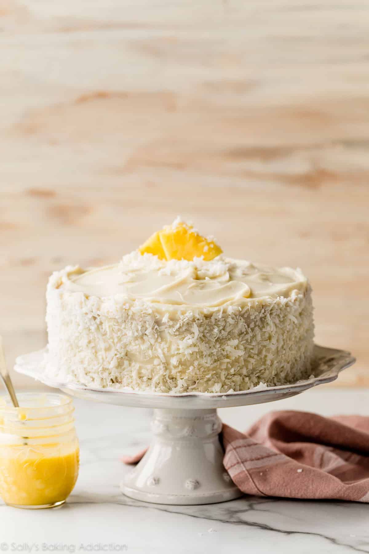 Scrumptious pineapple coconut cake on a cake tray.