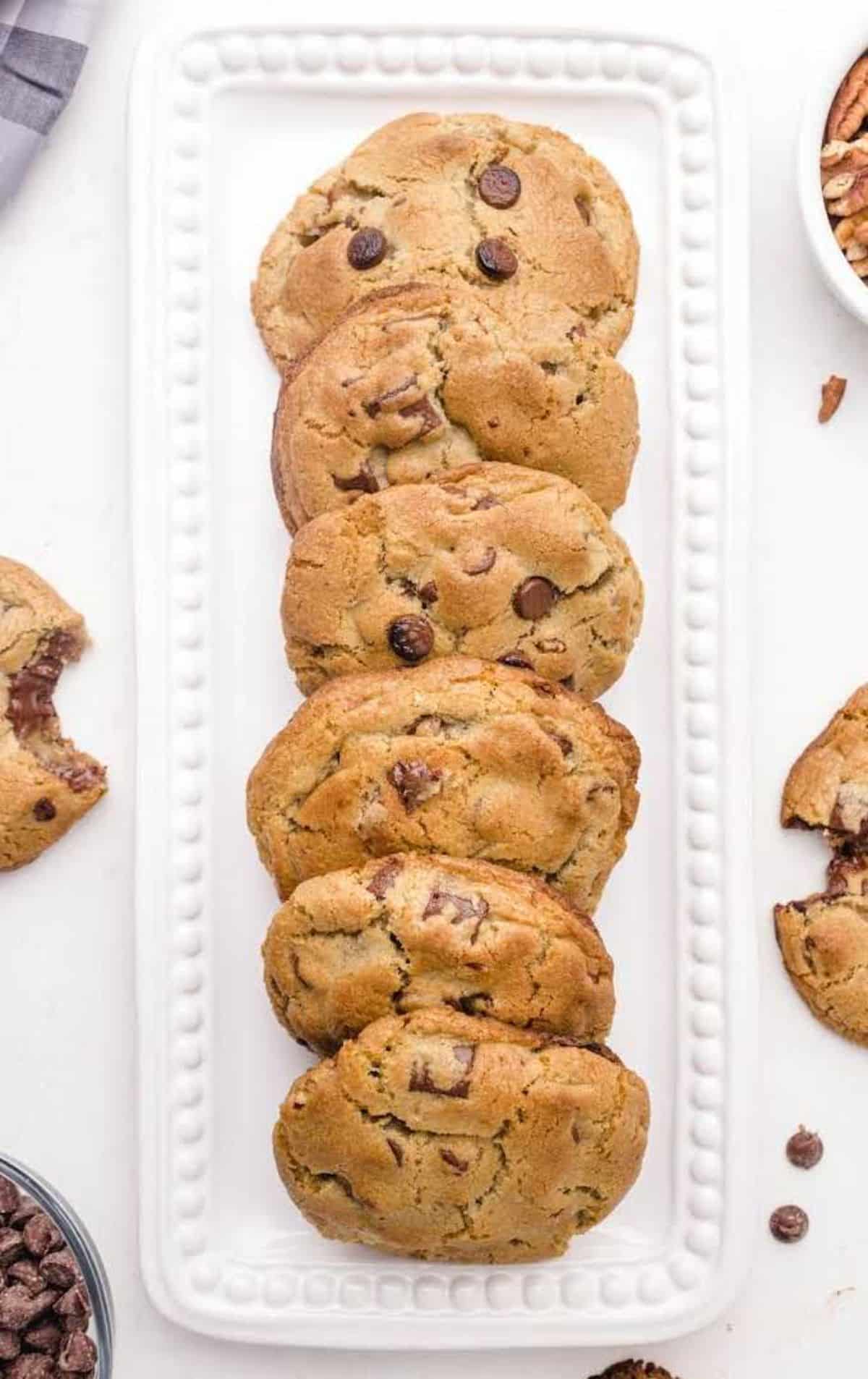 A bunch of ooey gooey chocolate brownies on a white tray.