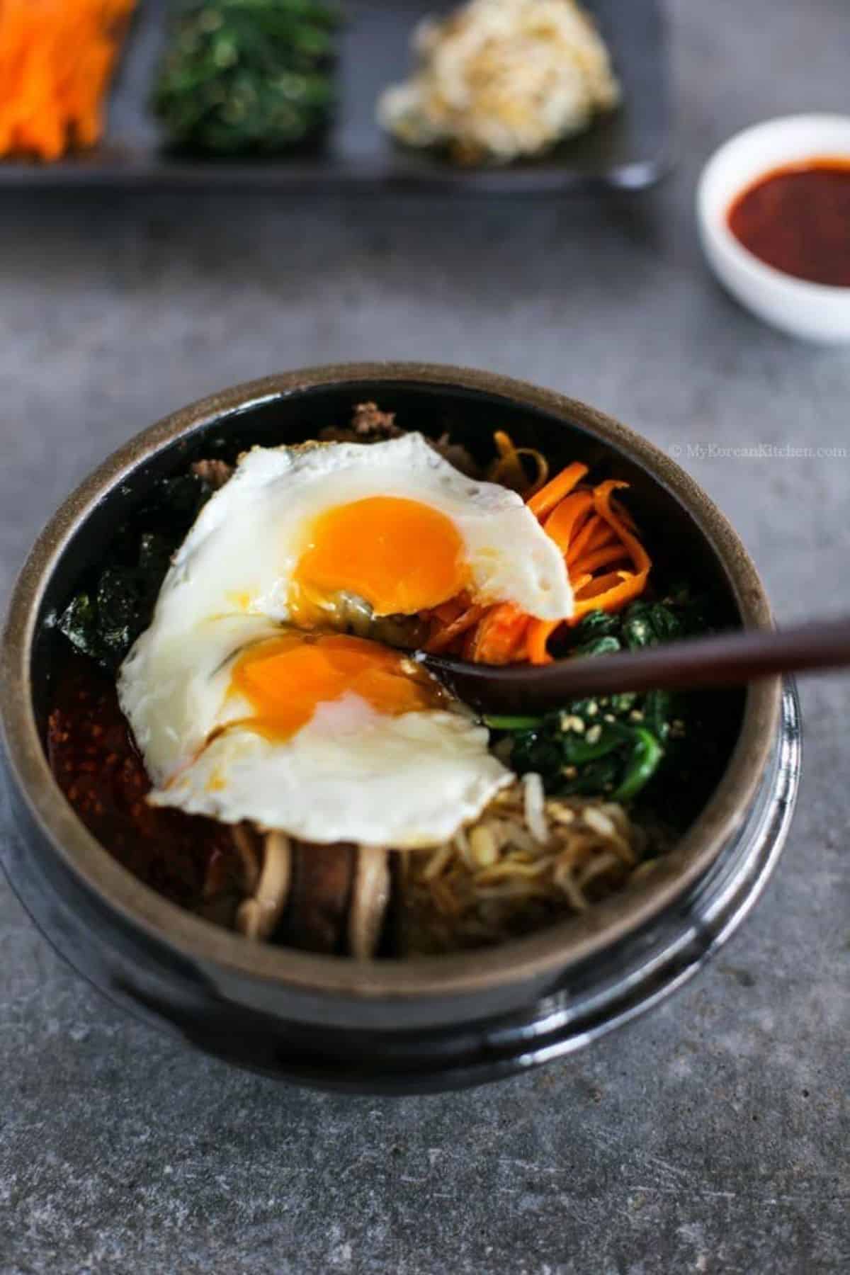 Delicious bibimbap in a gray bowl.