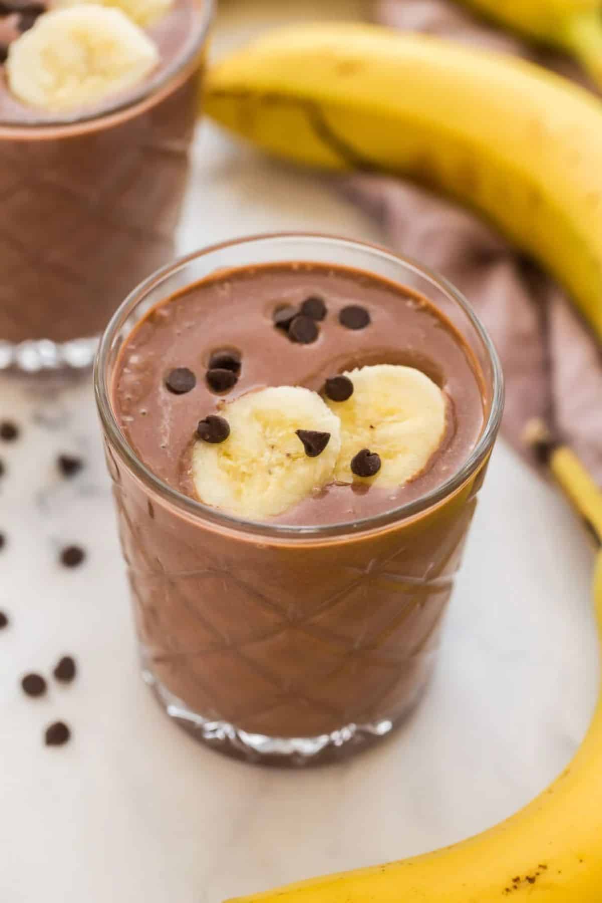 Mouth-watering chocolate peanut butter smoothie in a glass cup.