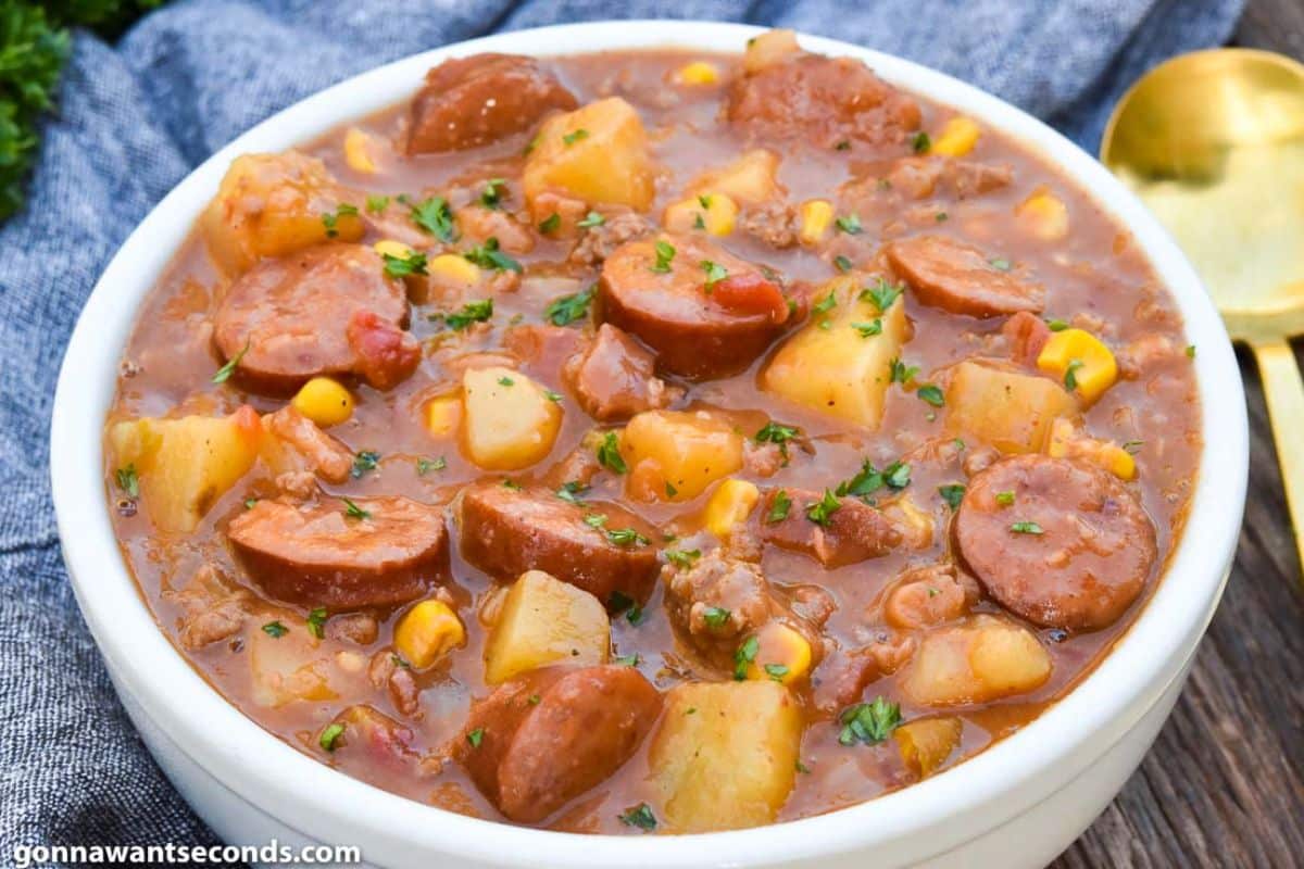 Hearty cowboy stew in a white bowl.