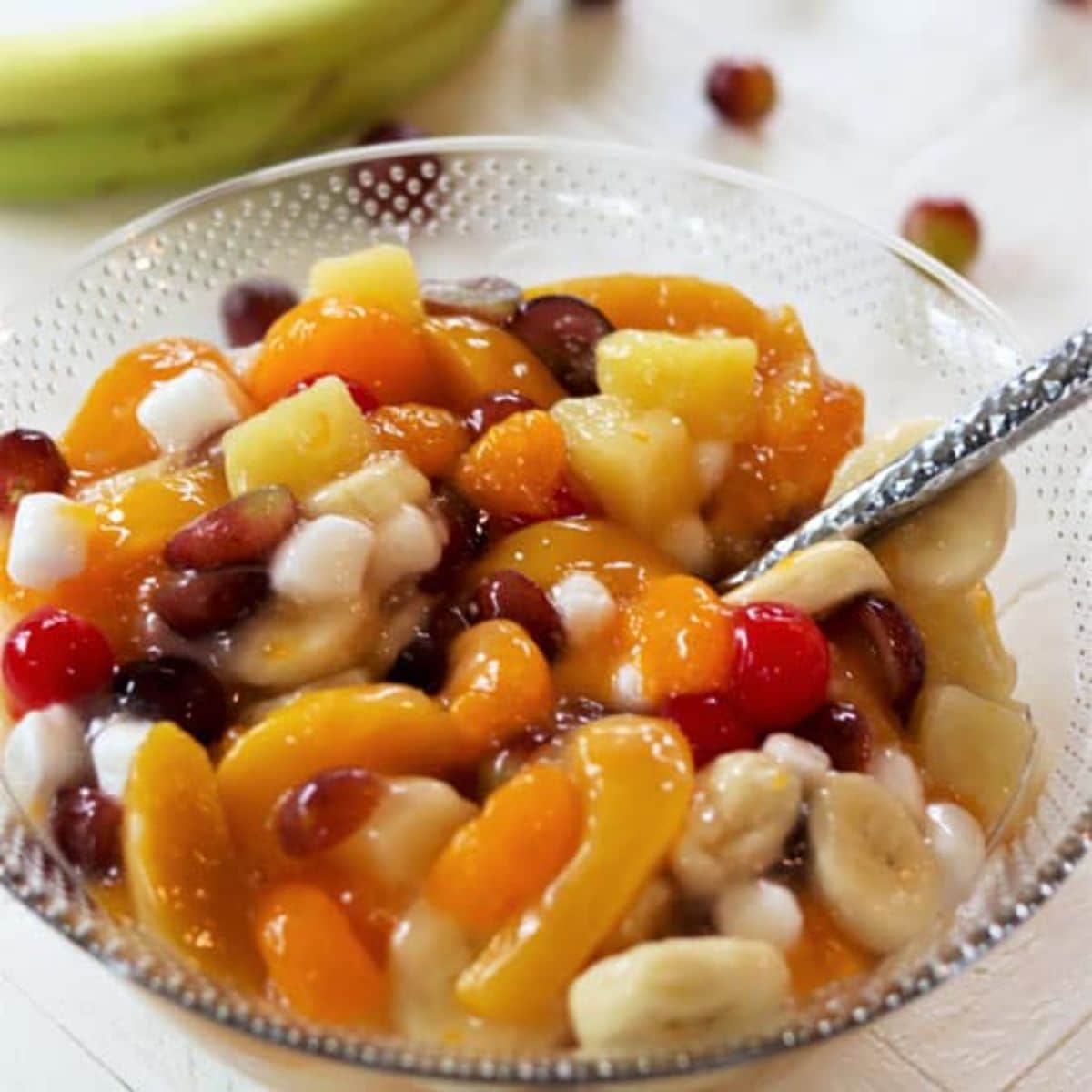 Healthy canned fruit salad in a glass bowl.