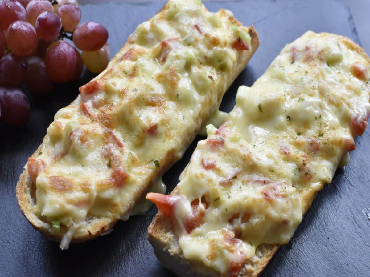 Juicy quick and easy crab melts on a black table.