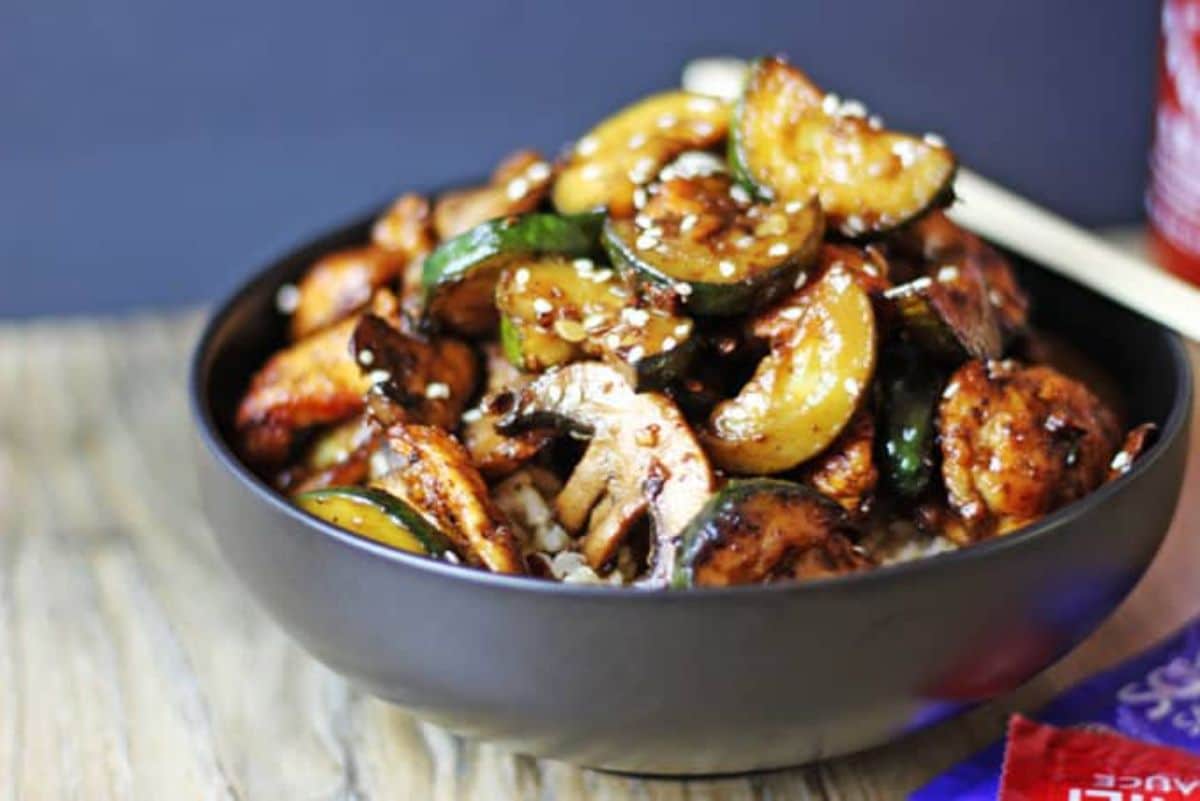 Juicy copycat panda express mushroom chicken in a gray bowl.