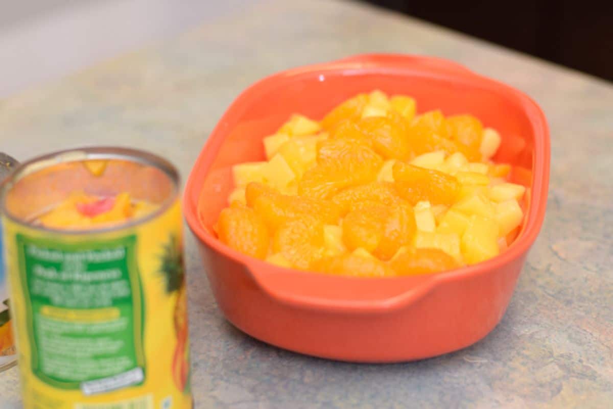 Healthy two-minute fruit salad in a red bowl.